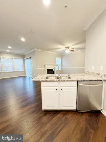 a large white kitchen with a white countertops and cabinets