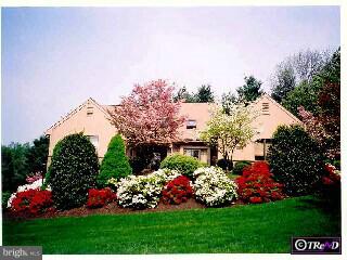 2 Raphael Road Hockessin, DE 19707 - Photo 1 of 6 a view of a garden with flowers and trees