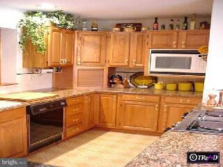 2 Raphael Road Hockessin, DE 19707 - Photo 4 of 6 a kitchen with stainless steel appliances granite countertop a stove a sink and a microwave