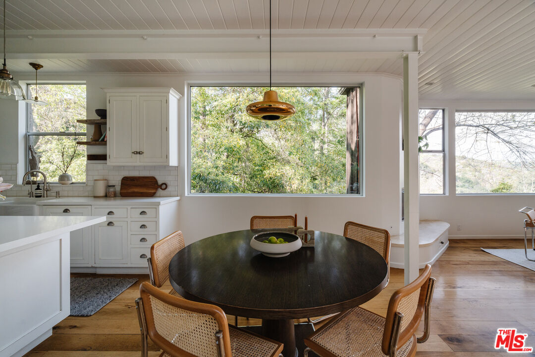 2355 Hermits Glen Los Angeles, CA 90046 - Photo 12 of 45 a kitchen with a table and chairs in it
