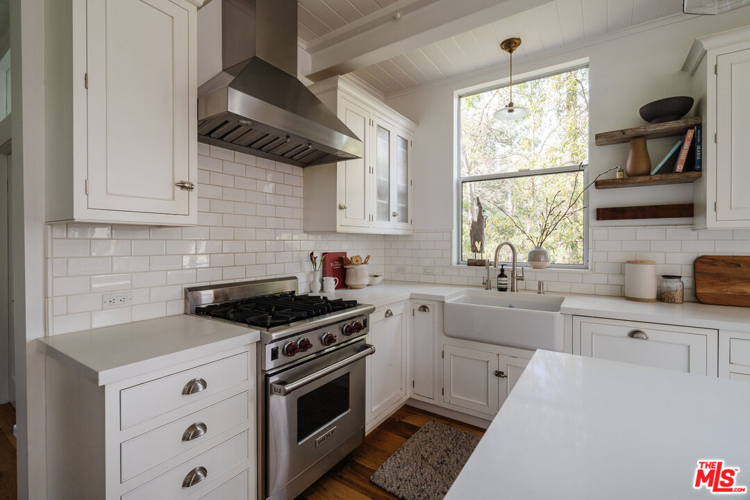 2355 Hermits Glen Los Angeles, CA 90046 - Photo 14 of 45 a kitchen with white cabinets and appliances
