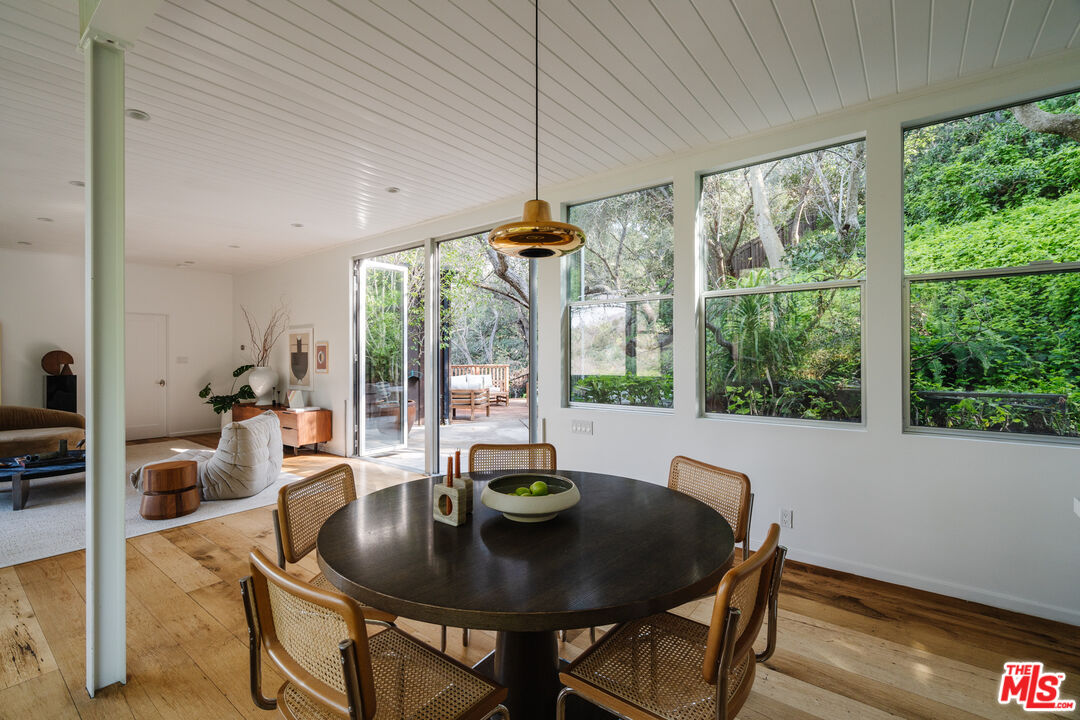 2355 Hermits Glen Los Angeles, CA 90046 - Photo 17 of 45 a dining room with furniture a chandelier and wooden floor