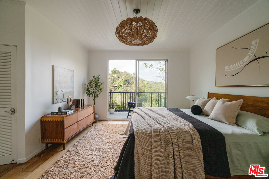 2355 Hermits Glen Los Angeles, CA 90046 - Photo 19 of 45 a bed room with a bed and a large window