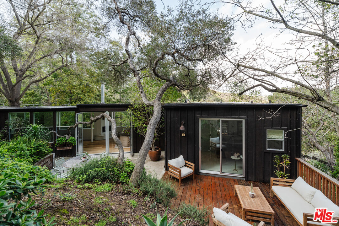 2355 Hermits Glen Los Angeles, CA 90046 - Photo 2 of 45 a view of a chair and table in backyard of the house