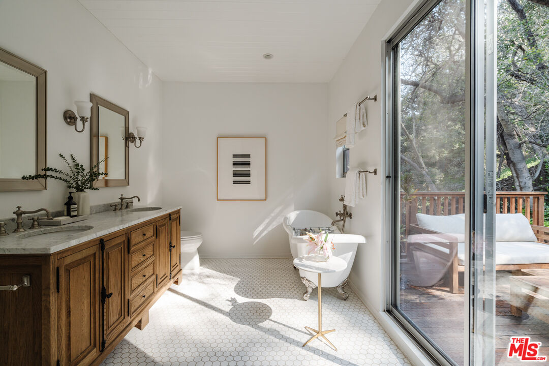 2355 Hermits Glen Los Angeles, CA 90046 - Photo 23 of 45 a spacious bathroom with a granite countertop sink a toilet a mirror and shower
