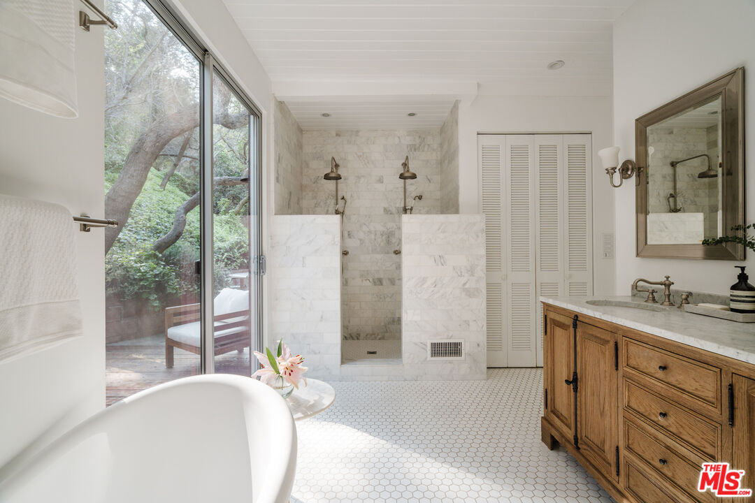 2355 Hermits Glen Los Angeles, CA 90046 - Photo 25 of 45 a spacious bathroom with a granite countertop tub sink a mirror a shower and vanity