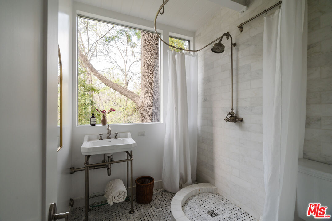 2355 Hermits Glen Los Angeles, CA 90046 - Photo 29 of 45 a bathroom with a sink toilet and a shower