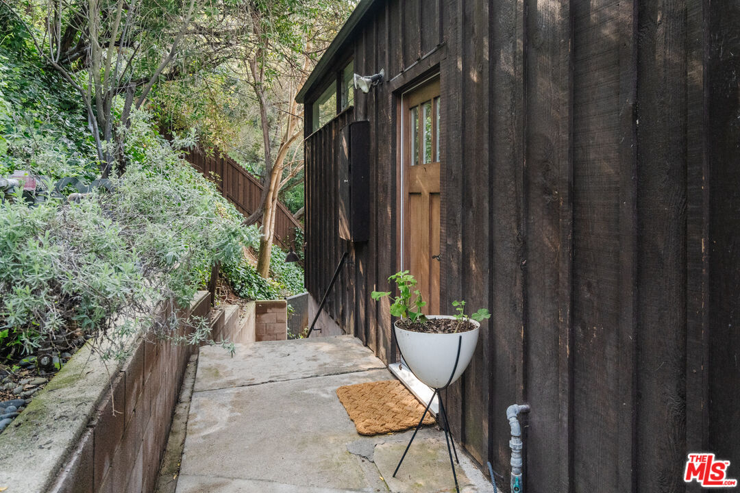 2355 Hermits Glen Los Angeles, CA 90046 - Photo 31 of 45 a view of a patio with table and chairs and potted plants