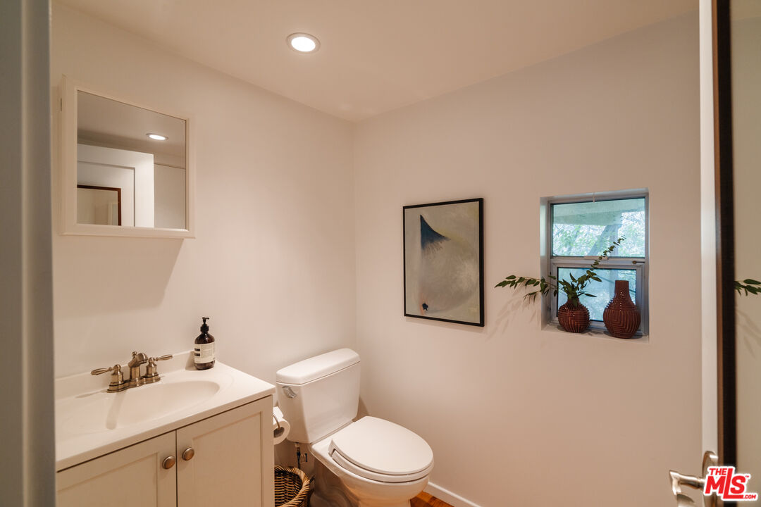 2355 Hermits Glen Los Angeles, CA 90046 - Photo 34 of 45 a bathroom with a sink a toilet and mirror