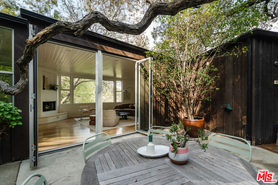 2355 Hermits Glen Los Angeles, CA 90046 - Photo 35 of 45 a view of a patio with table and chairs and potted plants