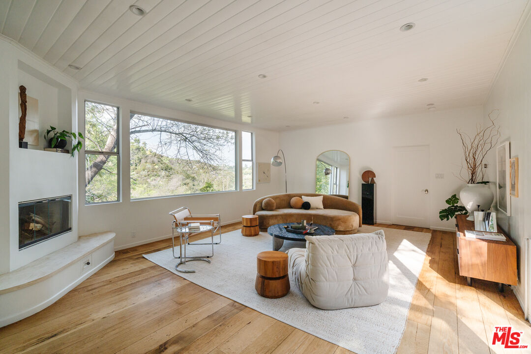 2355 Hermits Glen Los Angeles, CA 90046 - Photo 5 of 45 a living room with furniture and a fireplace