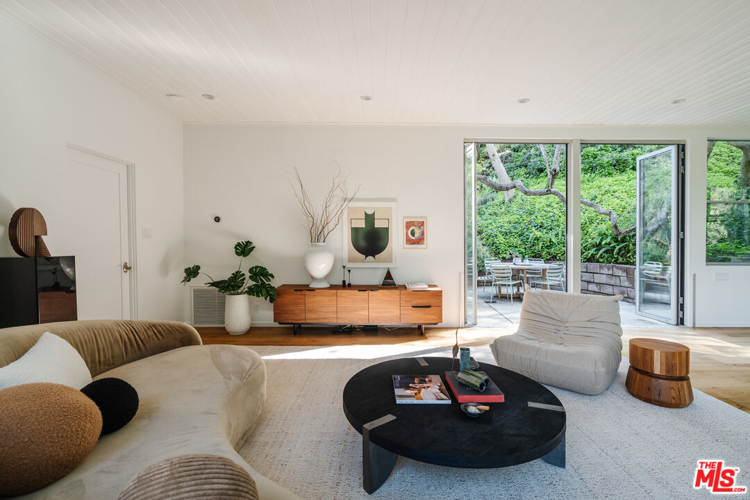 2355 Hermits Glen Los Angeles, CA 90046 - Photo 8 of 45 a living room with furniture and a floor to ceiling window