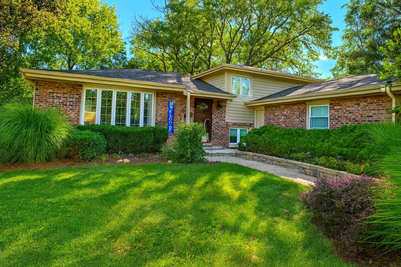 a front view of house with yard and green space
