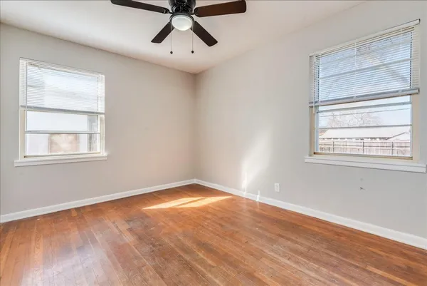 a view of a room with wooden floor and windows