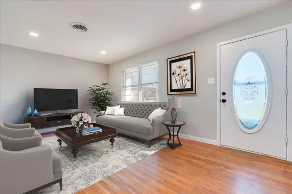 a living room with furniture a rug and a window