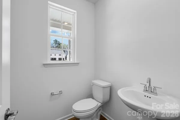 a white toilet sitting next to a bathroom sink
