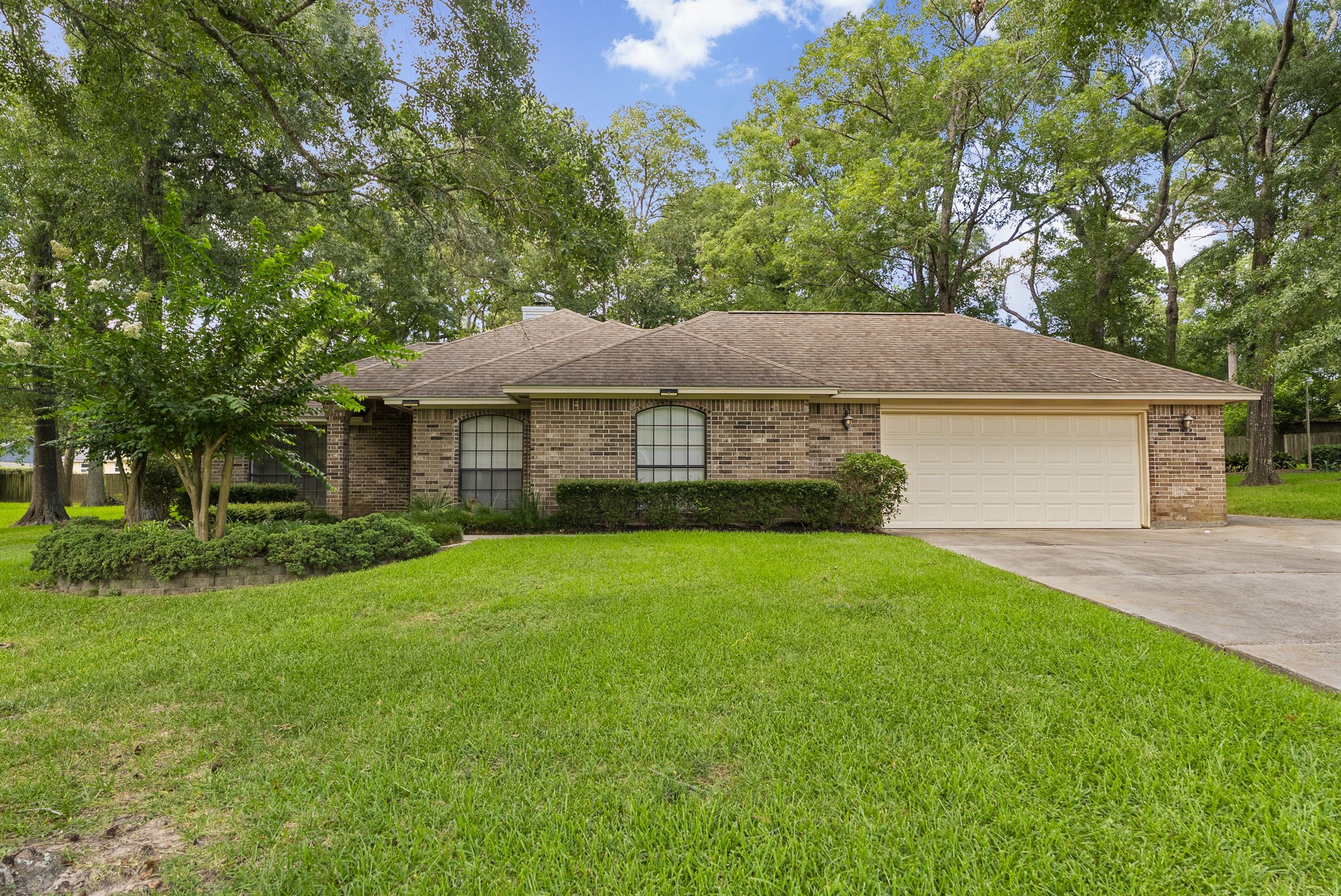 202 Sunset Boulevard Conroe, TX 77303 - Photo 1 of 50 Welcome home to this charming brick residence, nestled amidst lush greenery, offering a serene retreat with its spacious yard and inviting curb appeal.