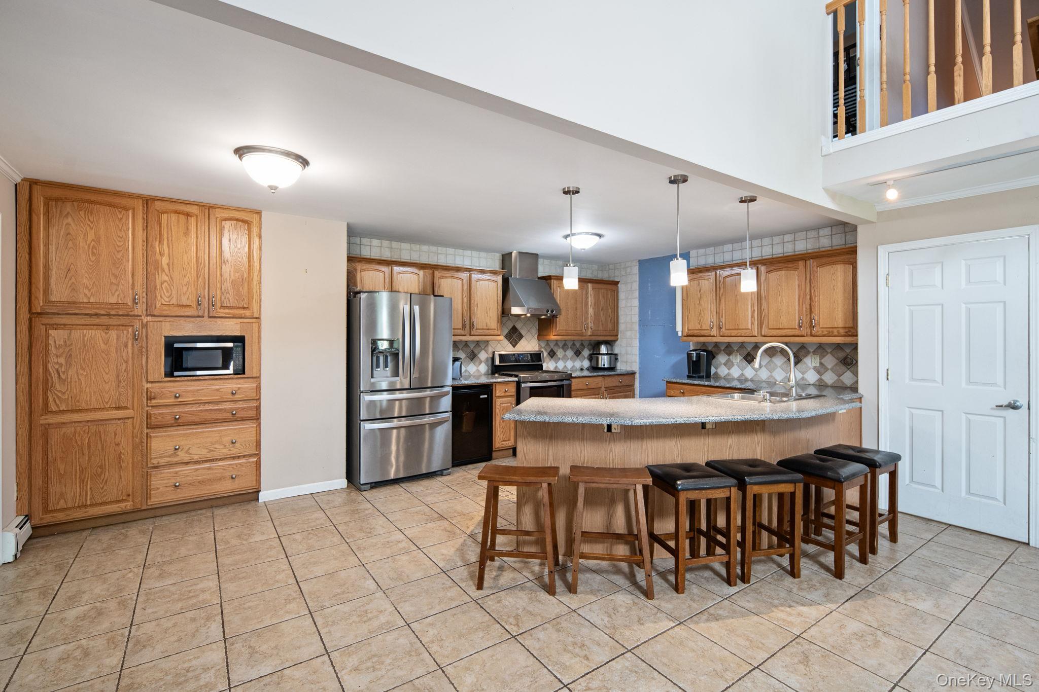 66 Highland Lake Road Eldred, NY 12732 - Photo 17 of 50 a kitchen with stainless steel appliances a refrigerator and a stove top oven
