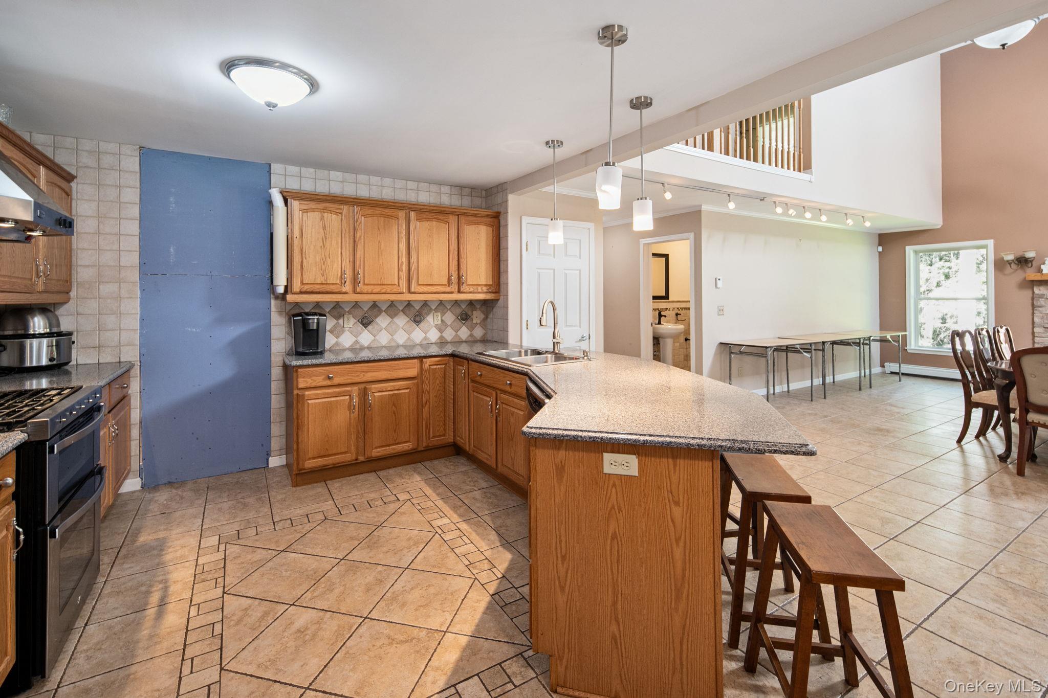 66 Highland Lake Road Eldred, NY 12732 - Photo 18 of 50 a kitchen with stainless steel appliances kitchen island granite countertop a sink and cabinets