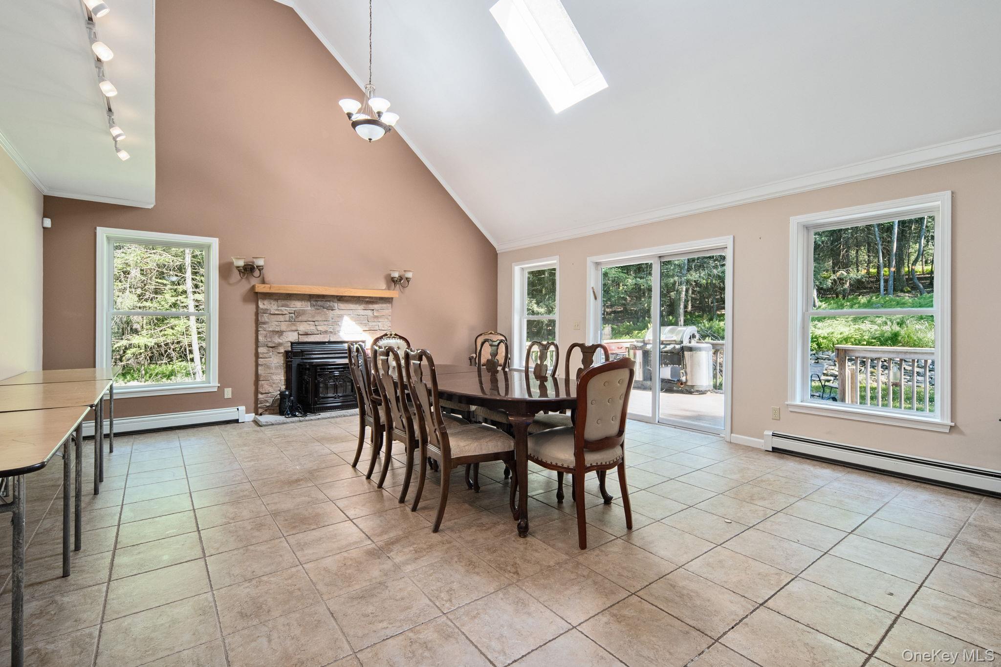 66 Highland Lake Road Eldred, NY 12732 - Photo 34 of 50 a dining room with furniture and a fireplace