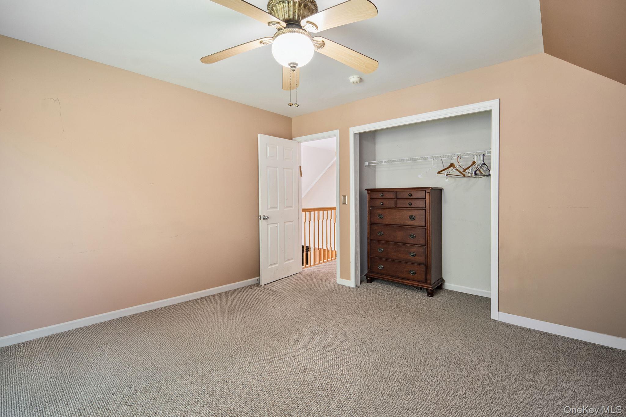 66 Highland Lake Road Eldred, NY 12732 - Photo 39 of 50 an empty room with closet and a ceiling fan