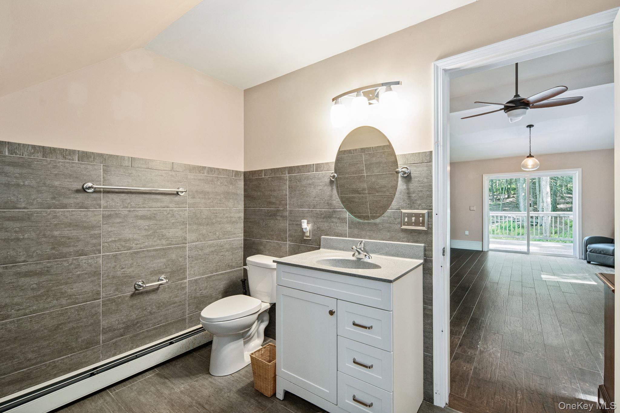 66 Highland Lake Road Eldred, NY 12732 - Photo 48 of 50 a bathroom with a toilet a sink and a mirror