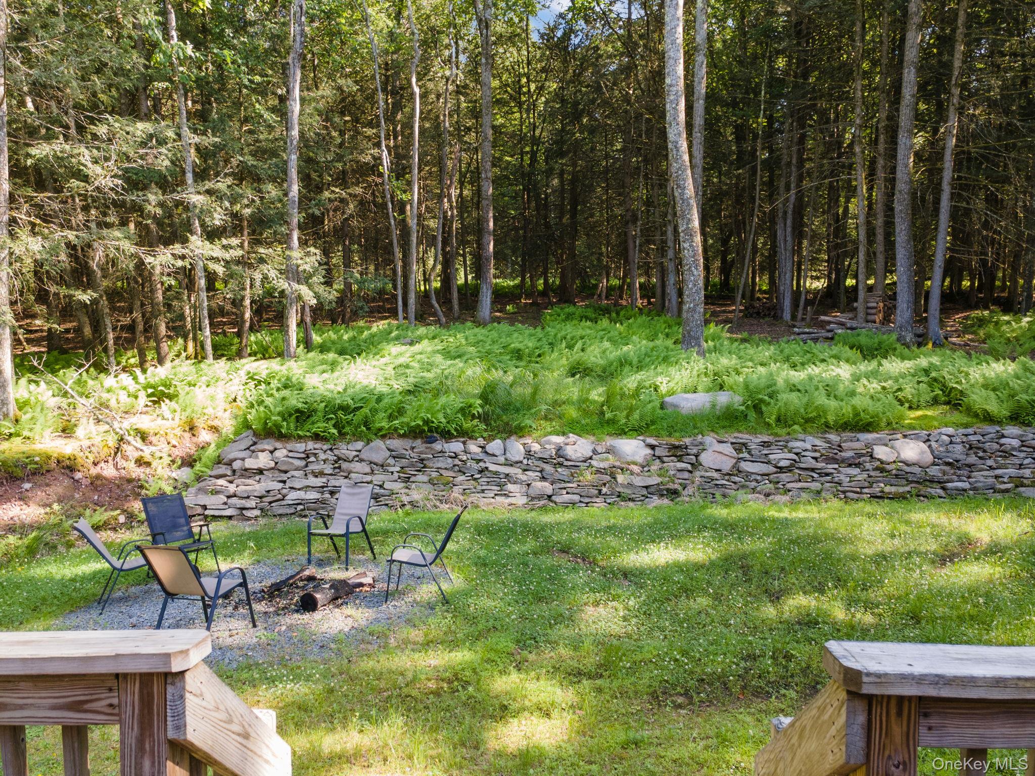 66 Highland Lake Road Eldred, NY 12732 - Photo 50 of 50 a swimming pool with outdoor seating and trees