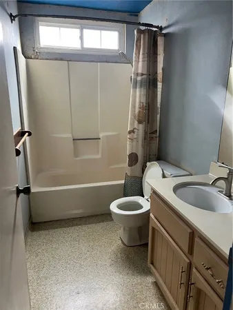 a bathroom with a toilet a sink and bathtub