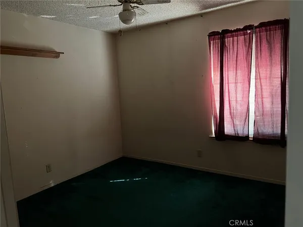 a view of a small space with wooden floor and a window