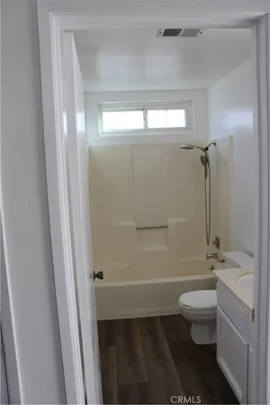 a bathroom with a toilet a sink and shower