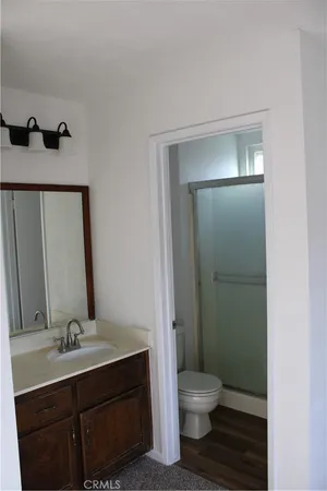 a bathroom with a toilet a sink and mirror