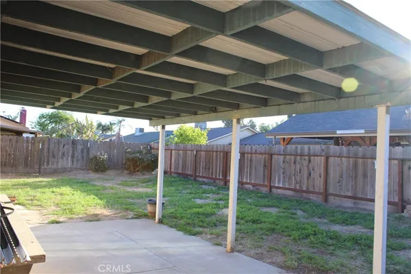 a view of a backyard with wooden fence