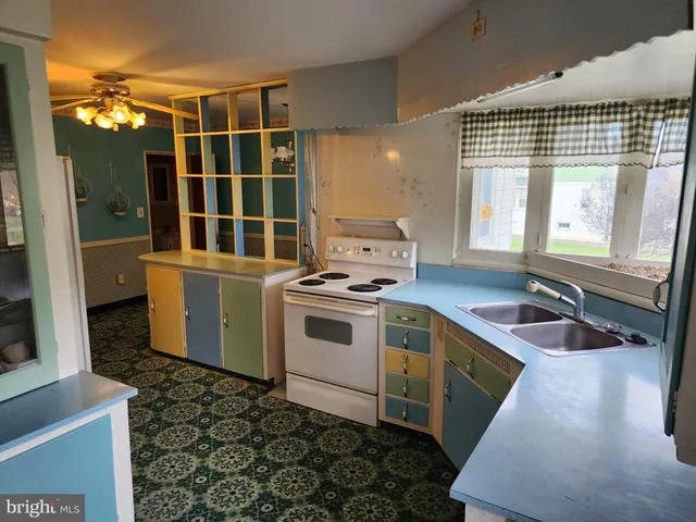a kitchen that has a sink and a stove