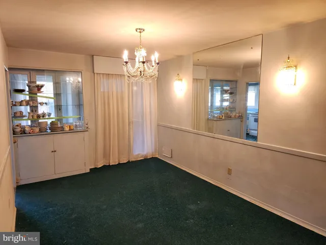 a view of a room with chandelier and wooden floor