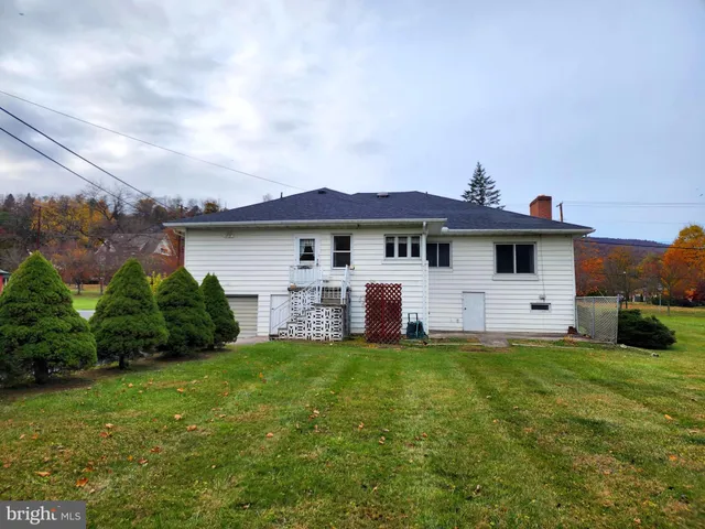 a front view of a house with a garden and deck