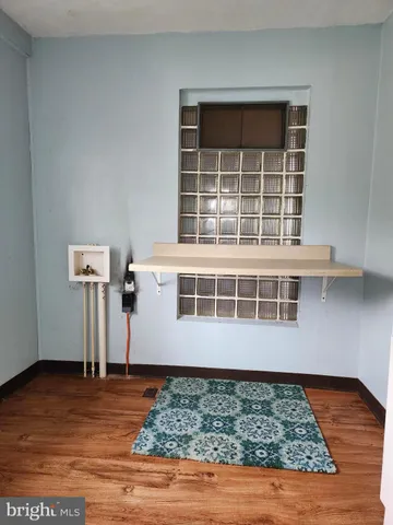 a view of a room with wooden floor and windows