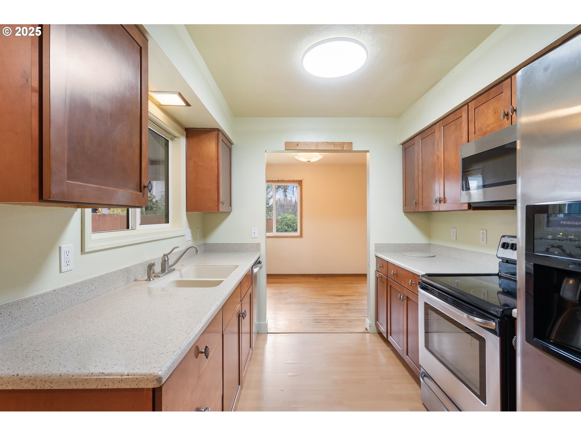 11010 Southeast Salmon Street Portland, OR 97216 - Photo 12 of 42 a kitchen with a sink and a refrigerator