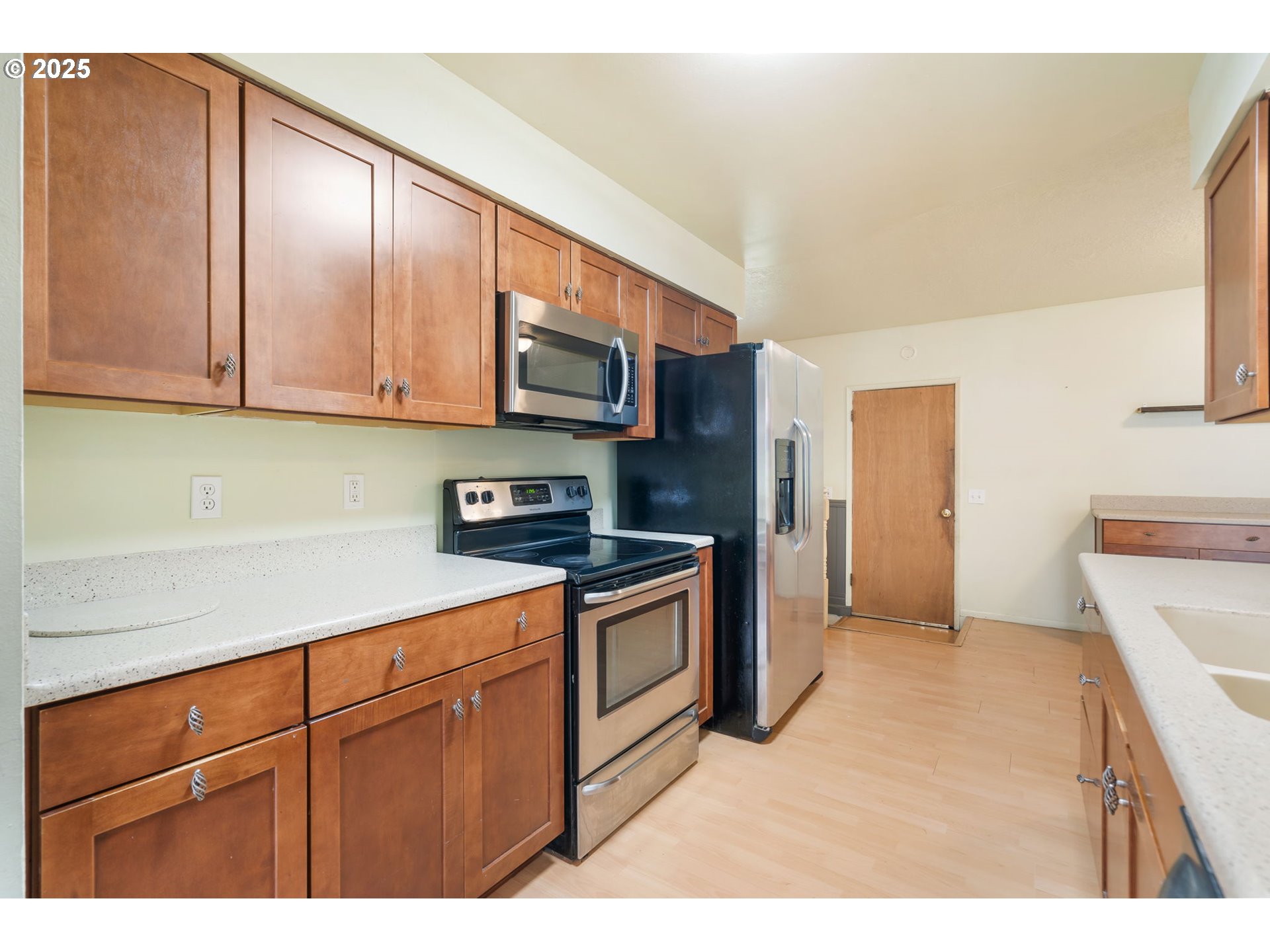11010 Southeast Salmon Street Portland, OR 97216 - Photo 13 of 42 a kitchen with stainless steel appliances granite countertop a refrigerator a stove a sink and dishwasher