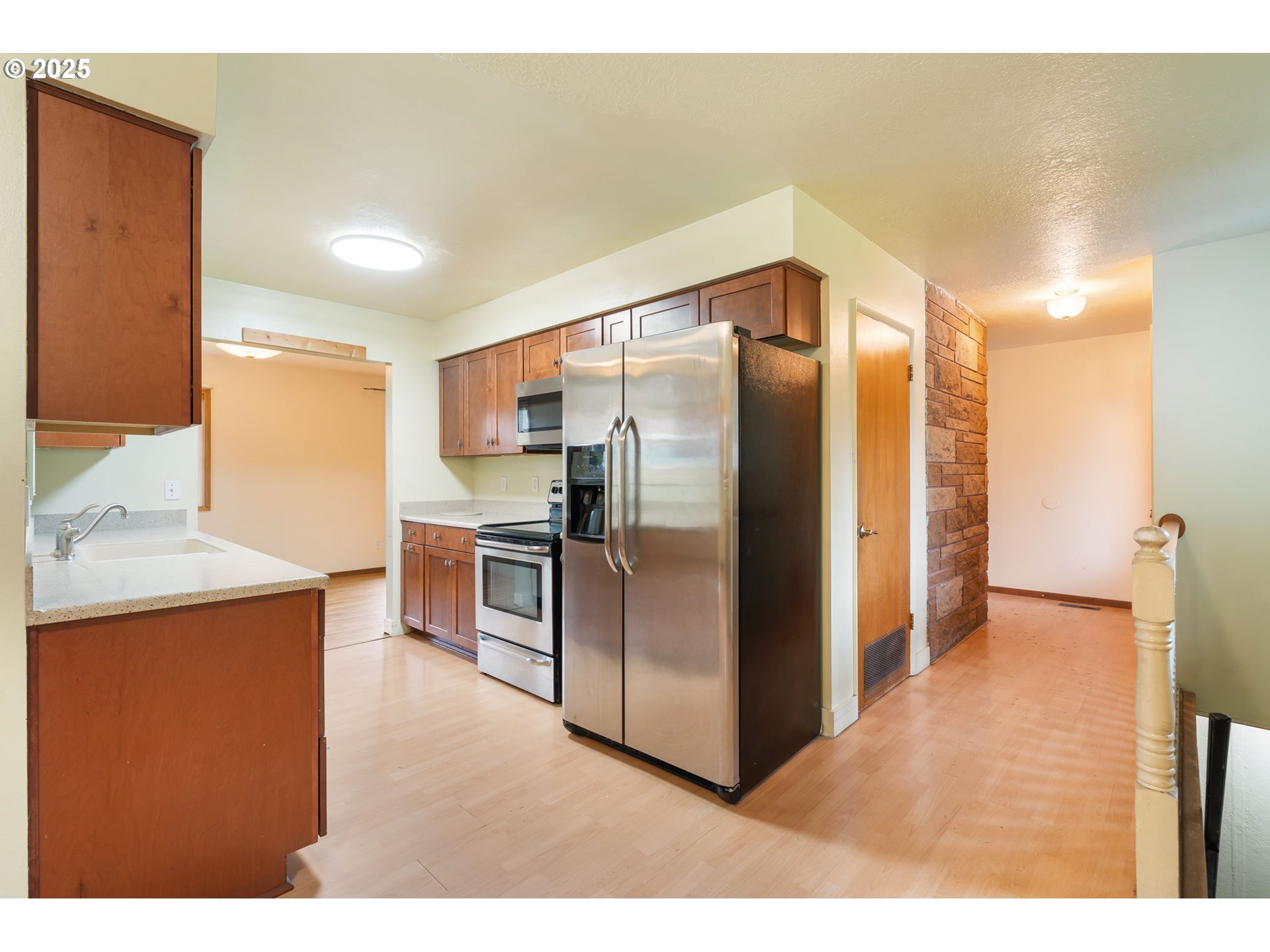 11010 Southeast Salmon Street Portland, OR 97216 - Photo 14 of 42 a kitchen with stainless steel appliances a refrigerator and a sink