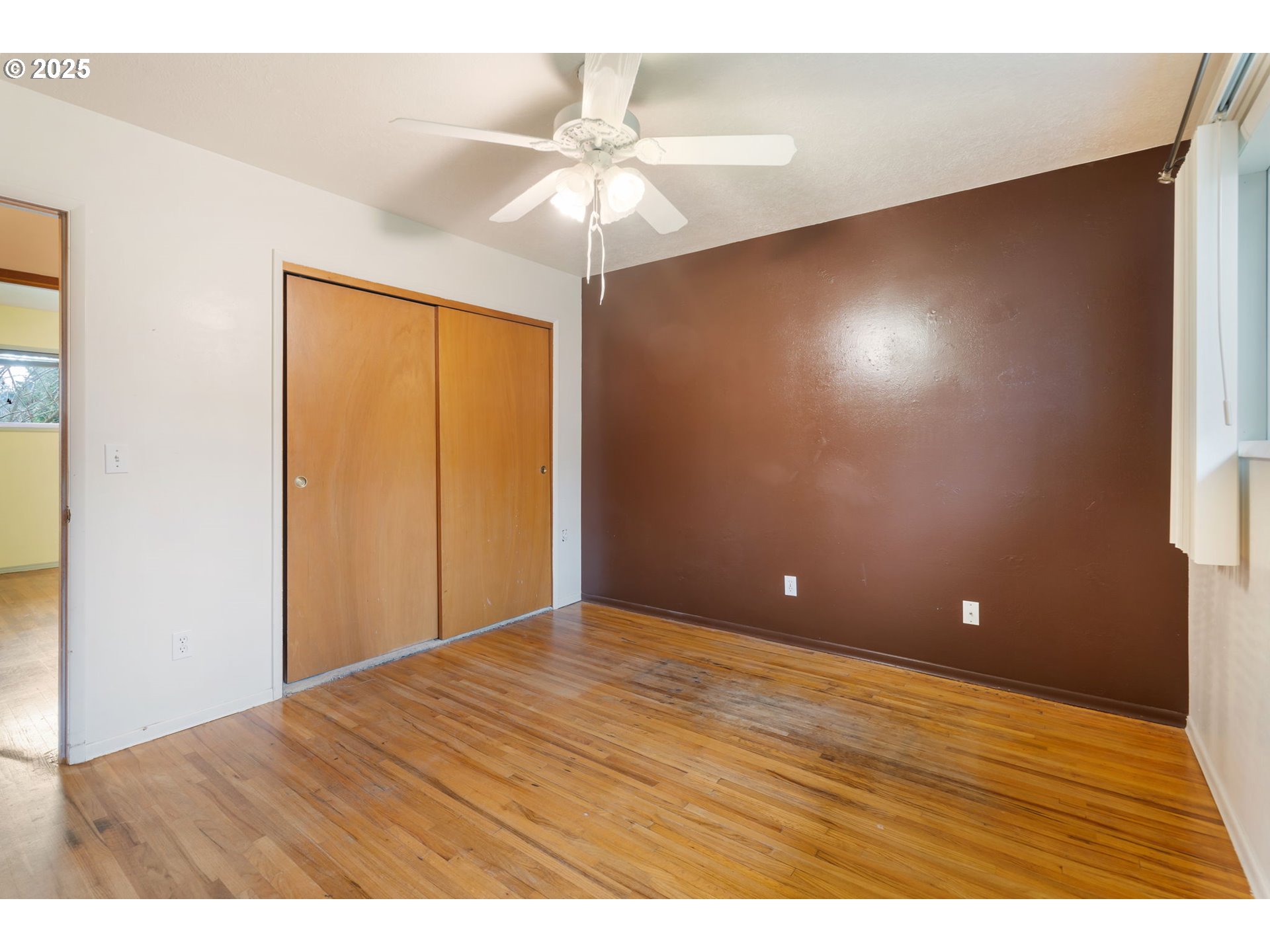 11010 Southeast Salmon Street Portland, OR 97216 - Photo 21 of 42 a view of an empty room with wooden floor and a ceiling fan