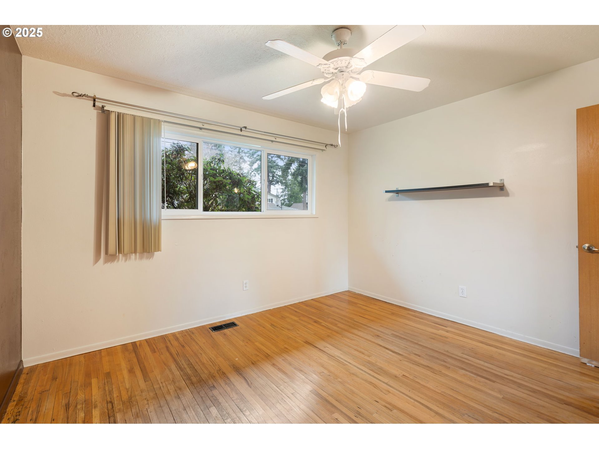 11010 Southeast Salmon Street Portland, OR 97216 - Photo 26 of 42 an empty room with wooden floor fan and windows