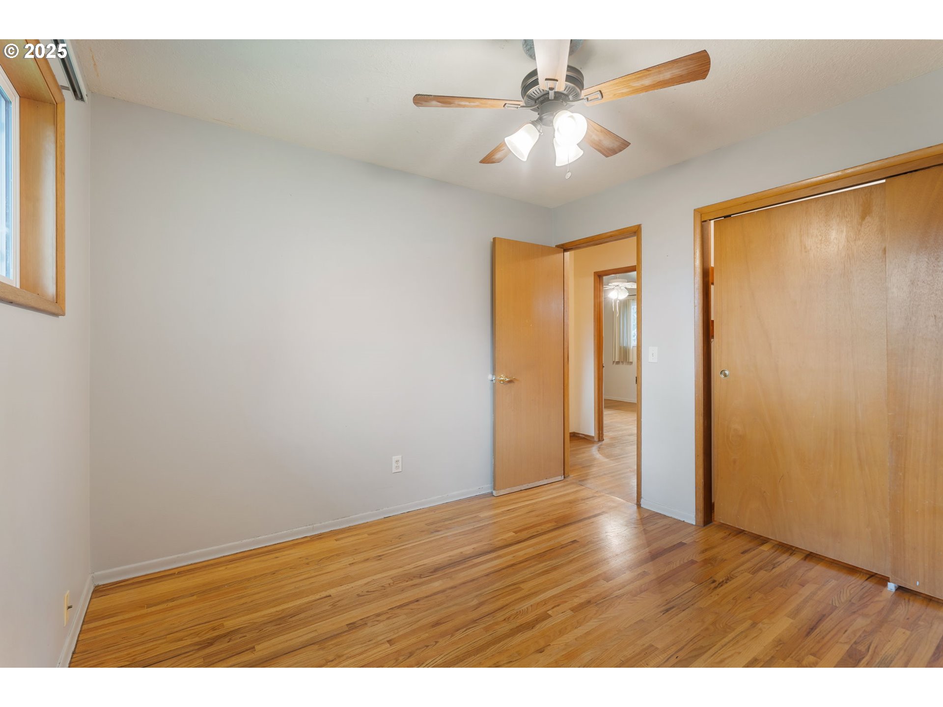 11010 Southeast Salmon Street Portland, OR 97216 - Photo 27 of 42 a view of an empty room with window and wooden floor