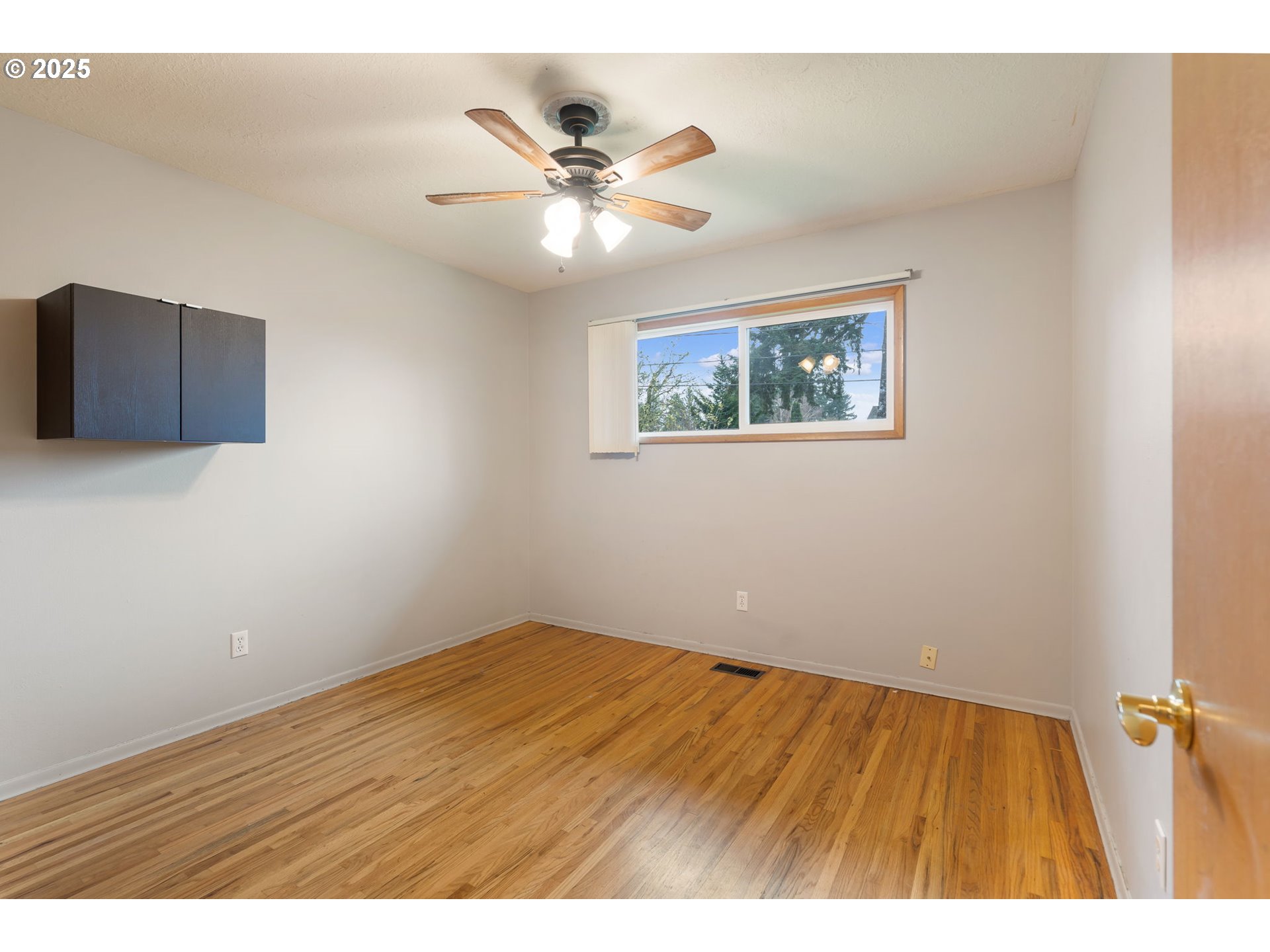 11010 Southeast Salmon Street Portland, OR 97216 - Photo 29 of 42 a view of an empty room with wooden floor