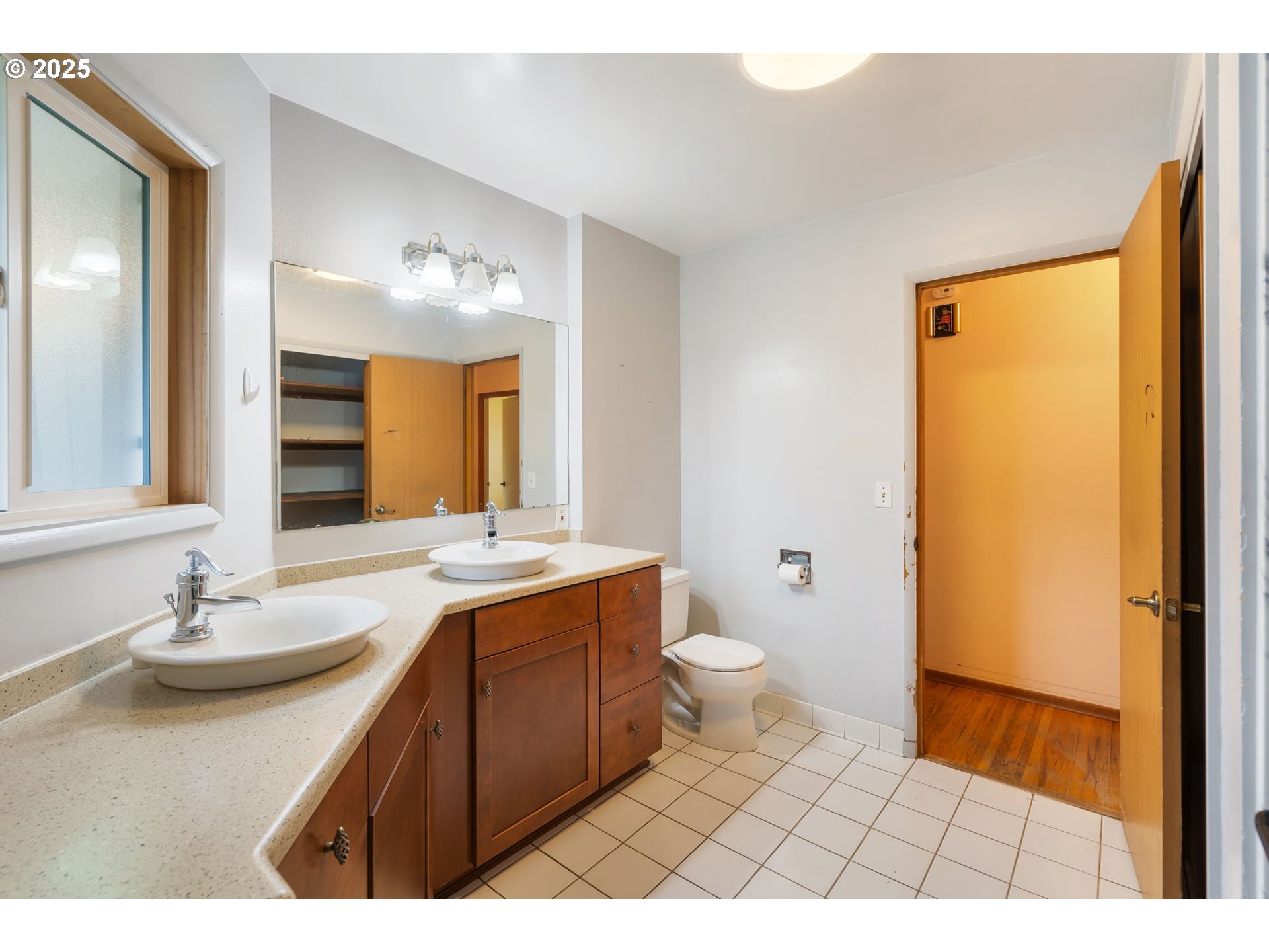 11010 Southeast Salmon Street Portland, OR 97216 - Photo 32 of 42 a bathroom with a sink a toilet and mirror