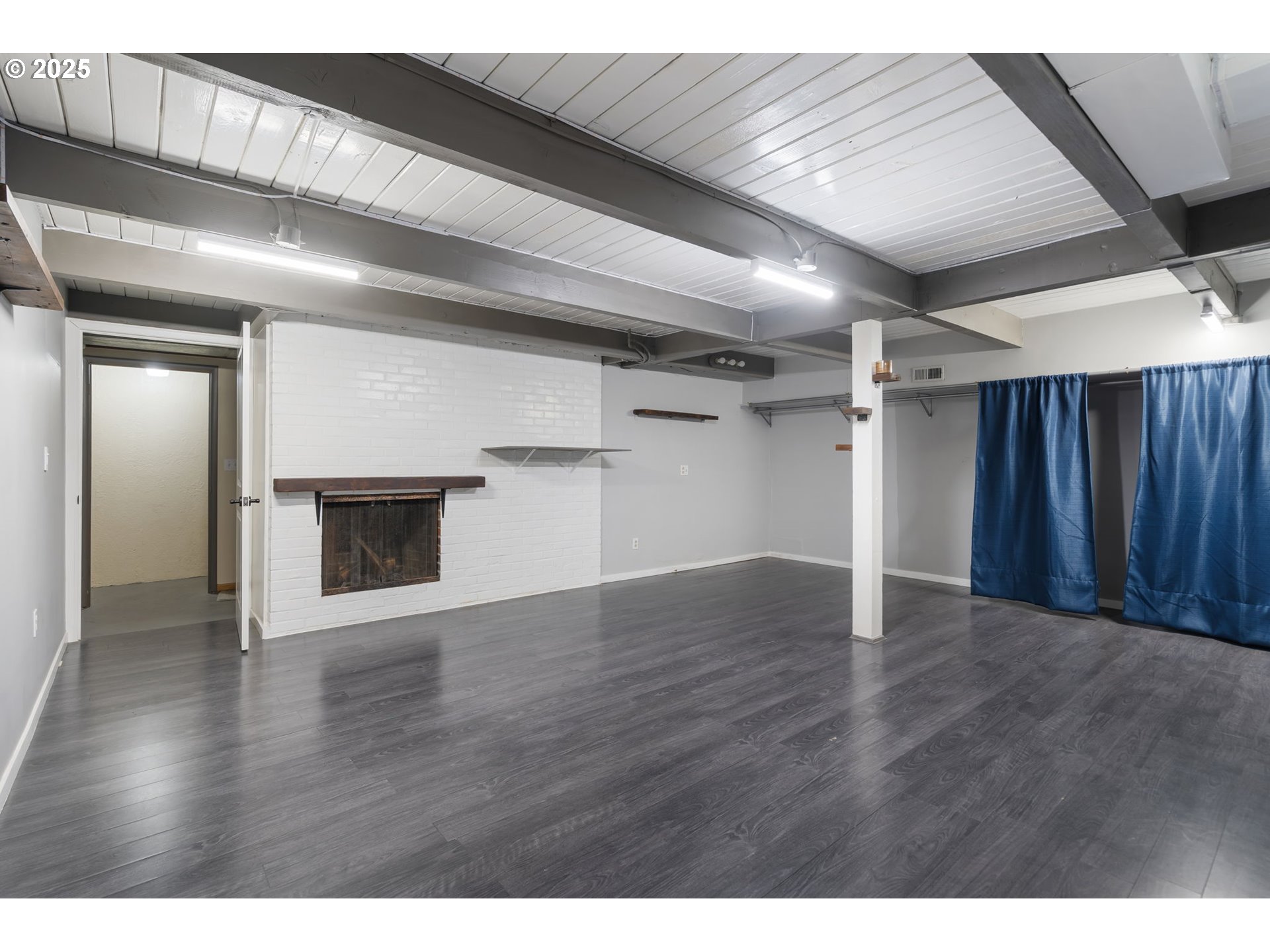 11010 Southeast Salmon Street Portland, OR 97216 - Photo 35 of 42 a view of an empty room with wooden floor