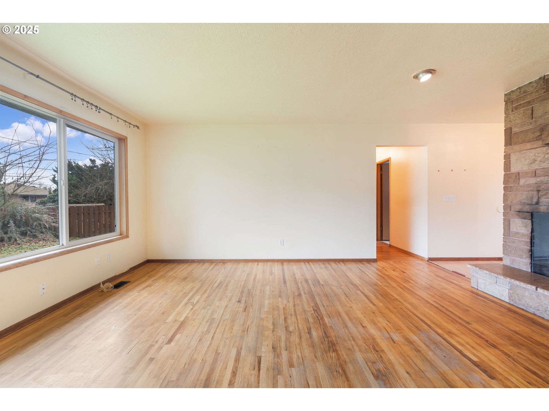 11010 Southeast Salmon Street Portland, OR 97216 - Photo 6 of 42 a view of an empty room and wooden floor