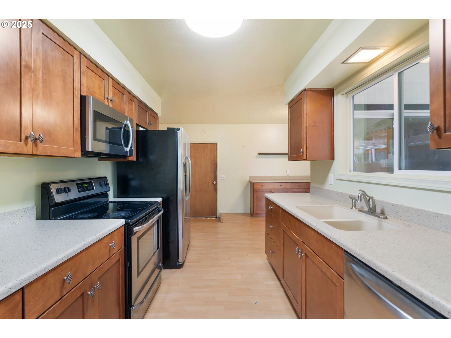 11010 Southeast Salmon Street Portland, OR 97216 - Photo 10 of 42 a kitchen with stainless steel appliances granite countertop a sink stove and refrigerator