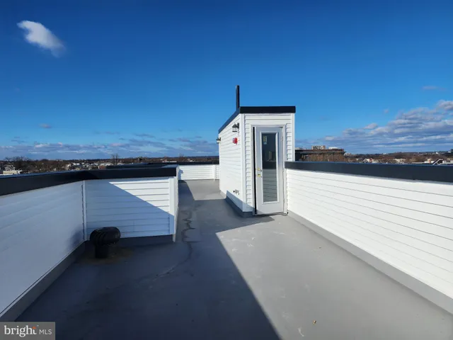 a view of a terrace with wooden floor and a ocean view