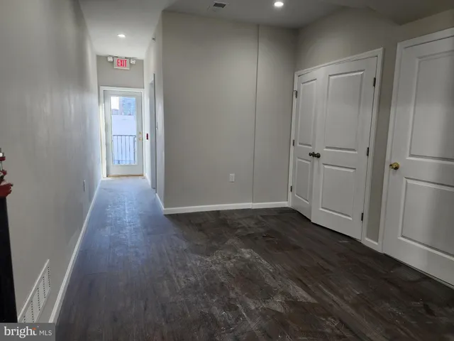 a view of hallway with wooden floor