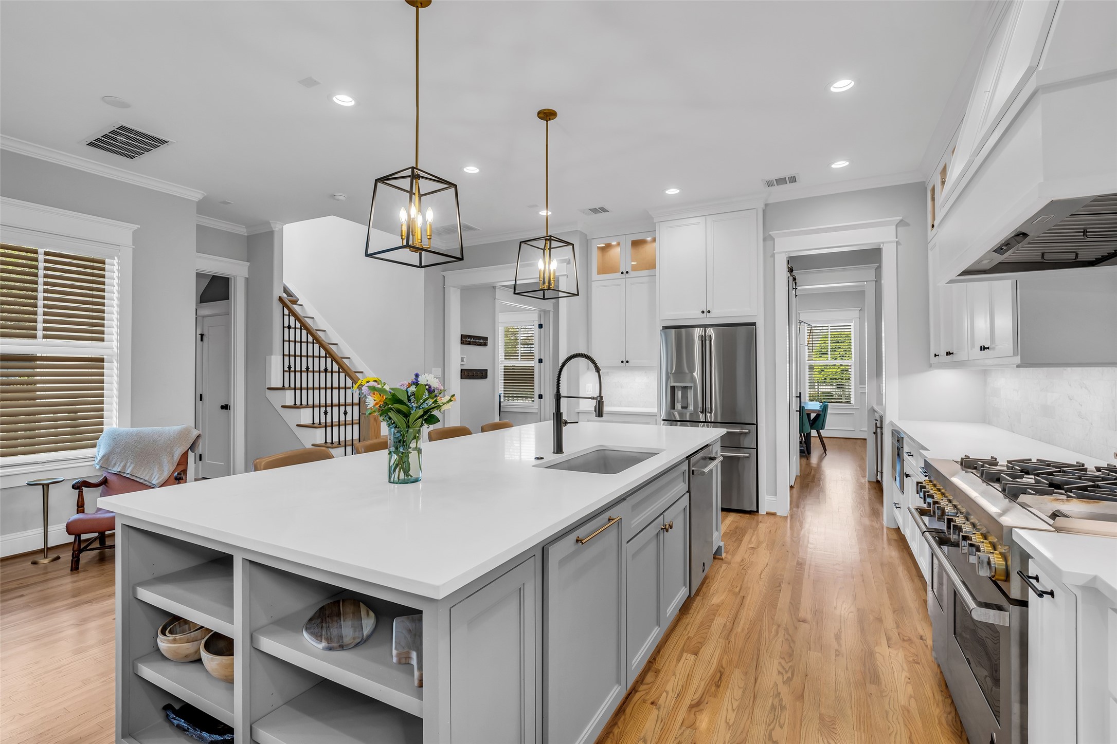 800 Walton Street Houston, TX 77009 - Photo 11 of 38 It features a spacious island with a built-in sink, providing ample workspace for food preparation and meal gatherings.